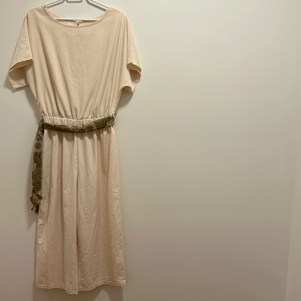 Cream short sleeve one-piece pant suit.